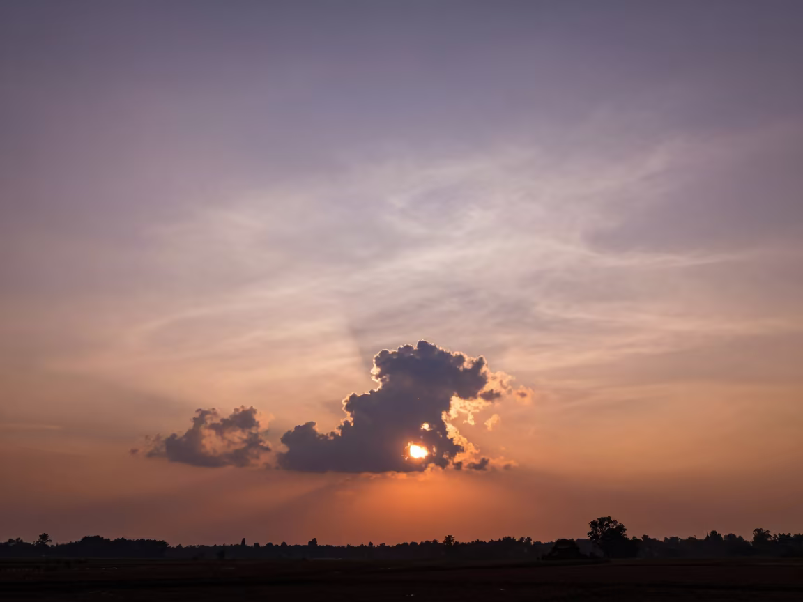 Iridescent Cloud Silhouette Against Sunset Thunderheads in over a horizon of stacked thunderheads near Kozhikode