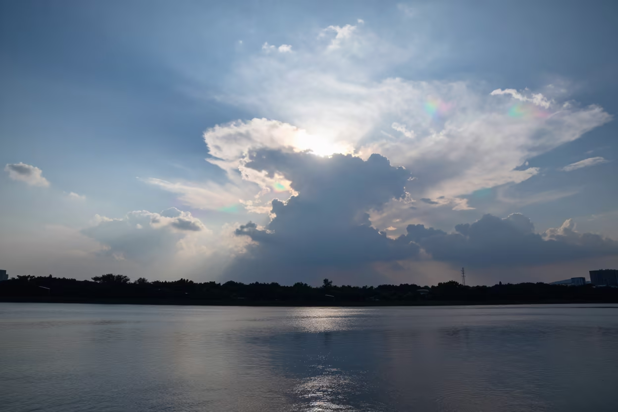 Iridescent Clouds Over Nanning Water in beneath fast-moving cloud bands near Nanning