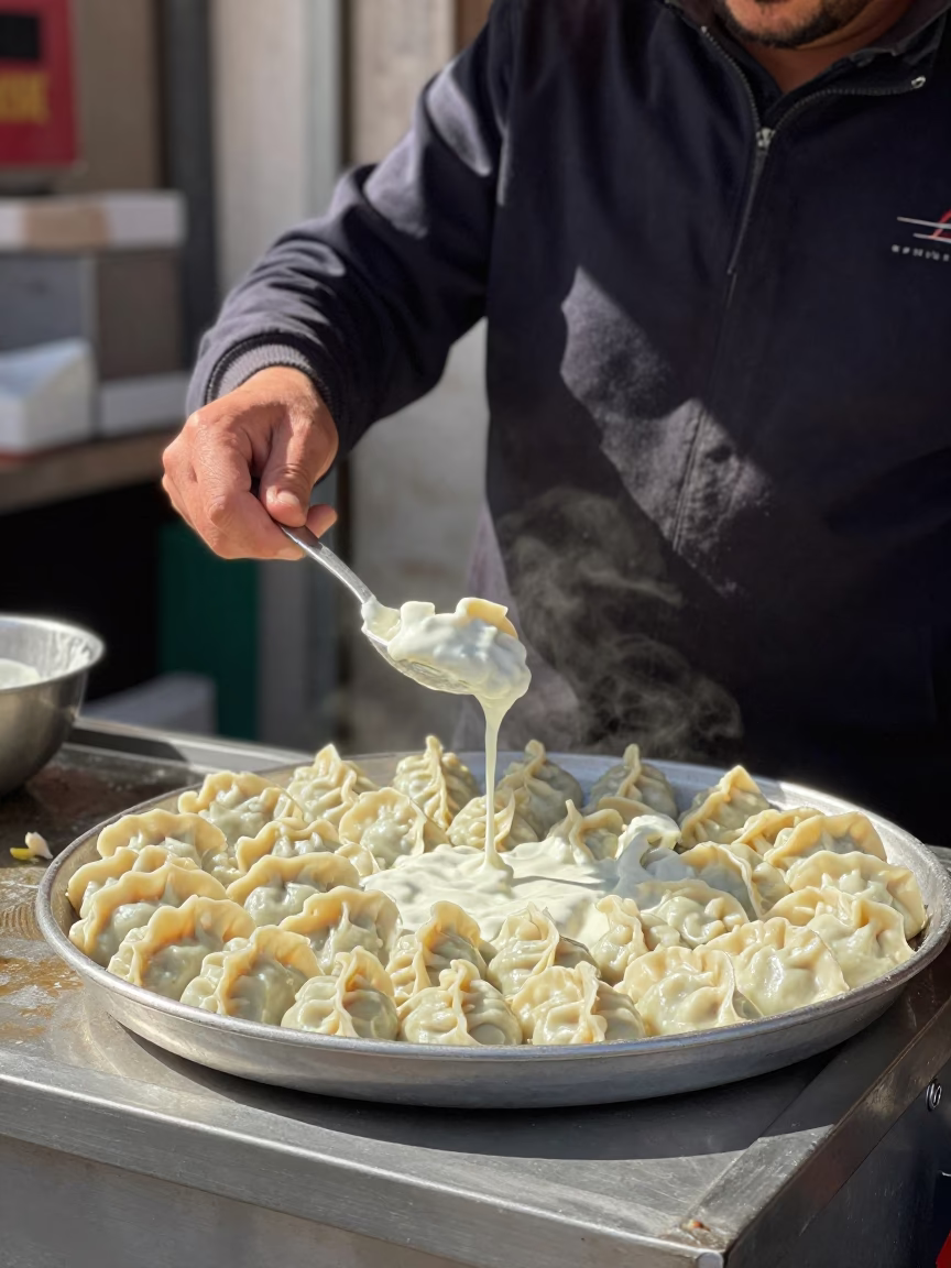 Istanbul Street Food Vendor Serving Manti Dumplings in Garlic Yogurt at Midday in in Istanbul, Turkey