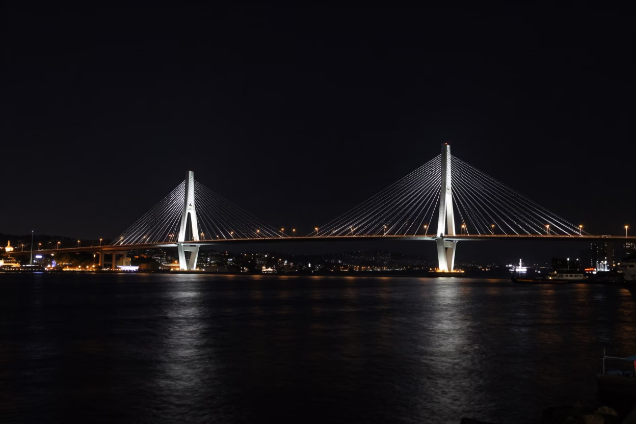 Izmir Midnight Harbor Cable-Stayed Bridge Illuminated Against Dark Water in in Izmir, Turkey