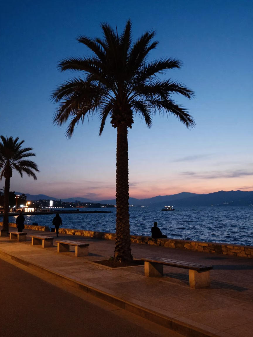 Izmir Turkey Blue Hour Street Scene with Palm Tree Silhouette and Coastal Life in in Izmir, Turkey