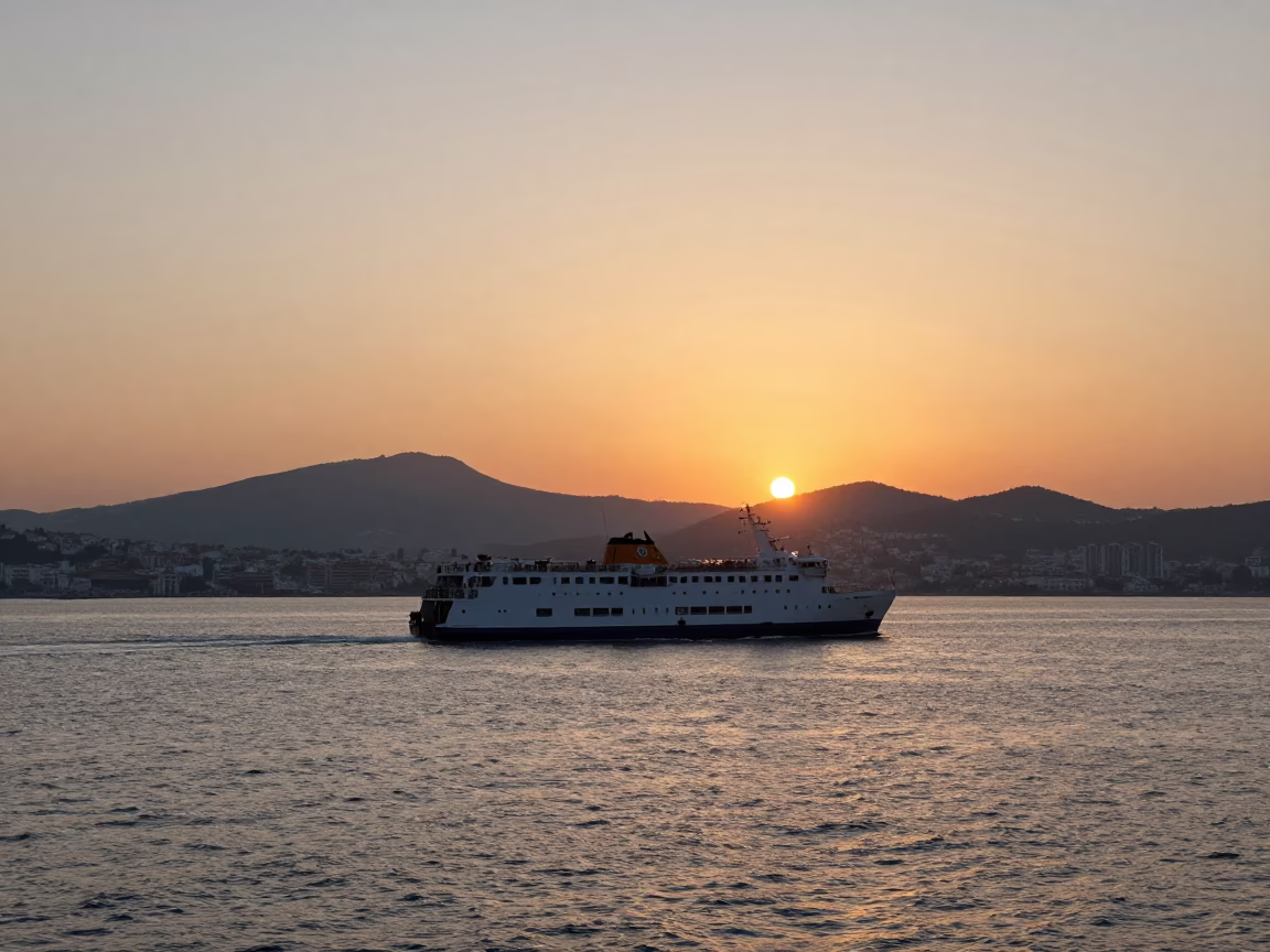 Izmir Turkey Sunset Ferry Departure from Harbor with Mountain Silhouettes and Evening Light in in Izmir, Turkey