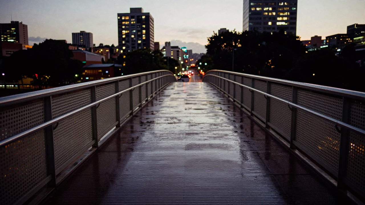 Johannesburg Pedestrian Overpass at Dusk with Wet Footsteps and City Lights in in Johannesburg, South Africa