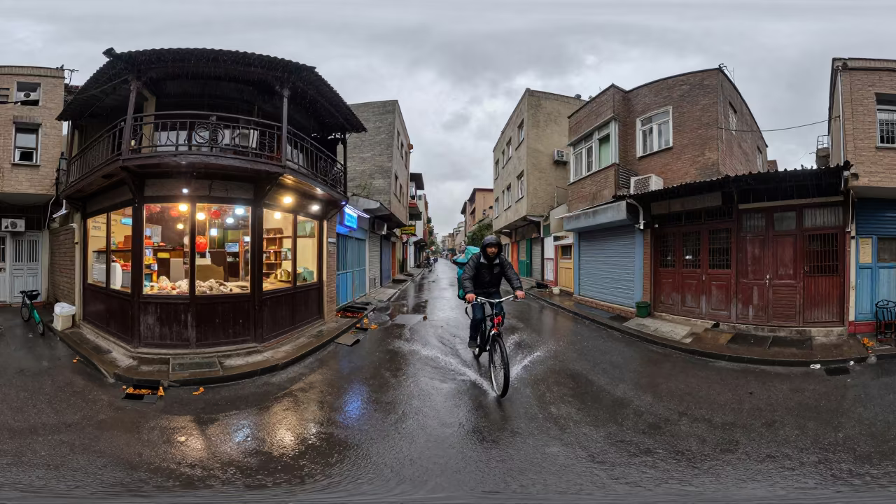 Kabul Cyclist Splashing Puddle Rain Darkened Kiosk in by a rain-darkened kiosk in Kabul