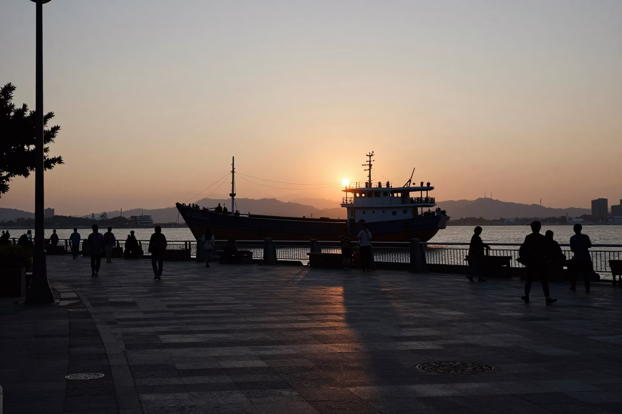 Kaohsiung Early Evening Street Scene with Junk Boat Silhouette and Urban Life in in Kaohsiung, Taiwan