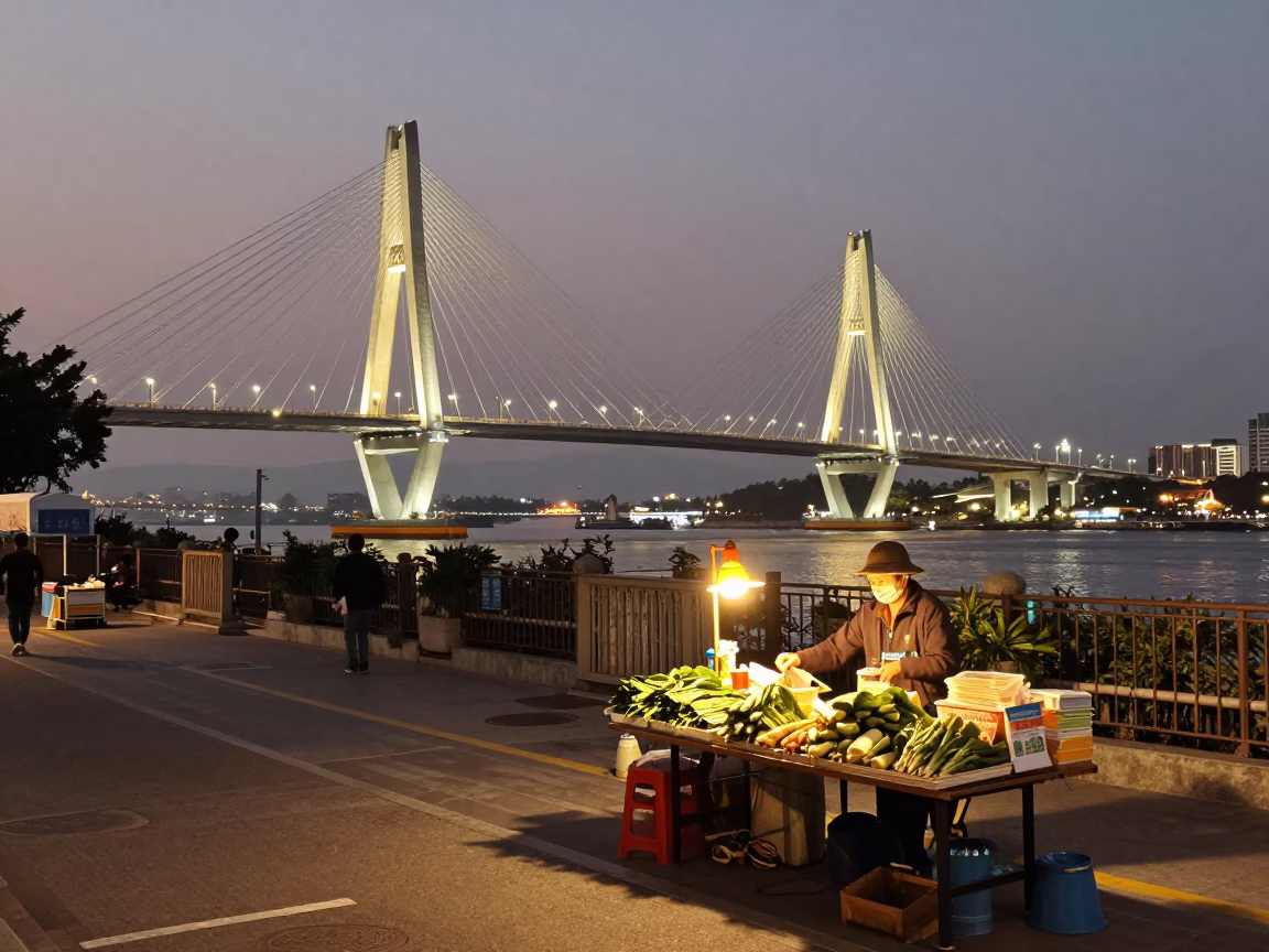 Kaohsiung evening street scene with cable-stayed bridge and local commerce in in Kaohsiung, Taiwan