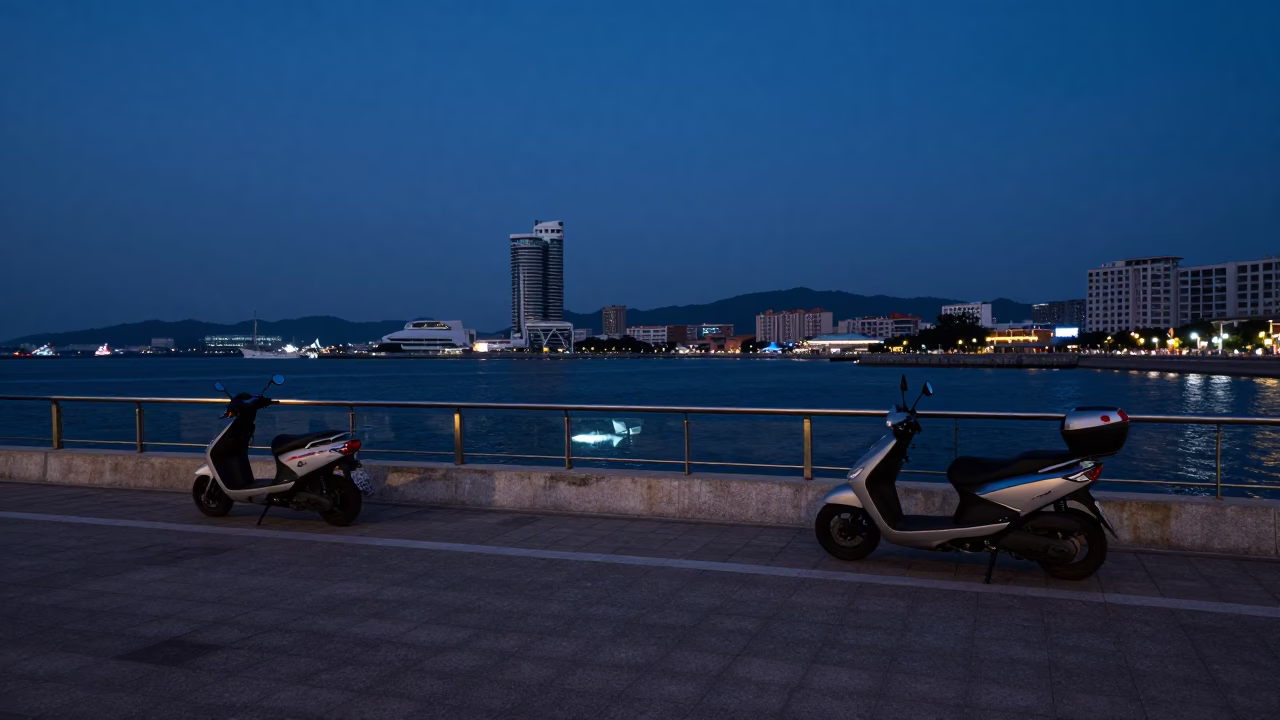 Kaohsiung Harbor Promenade Before Dawn with Scooter and Glass Wall in in Kaohsiung, Taiwan
