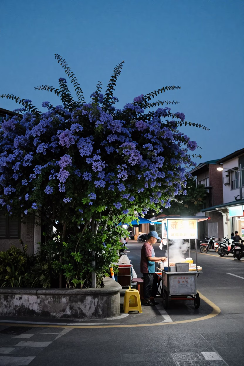 Kaohsiung indigo twilight street scene with plumbago hedge and busy night market activity in in Kaohsiung, Taiwan