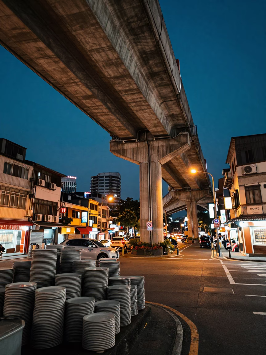 Kaohsiung Night Street Scene with Stacked Plates and Flyover Shadows at Dusk in in Kaohsiung, Taiwan