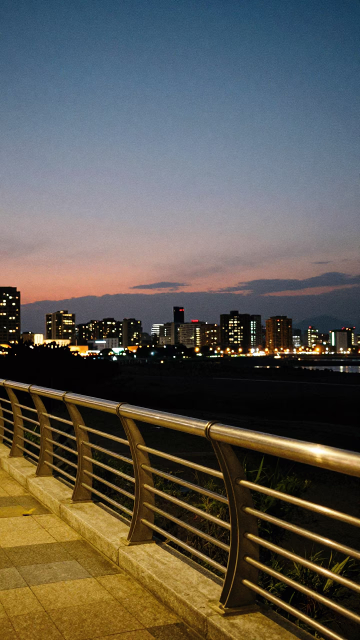 Kaohsiung Taiwan Evening Horizon Shot with Brushed Steel Rail and City Lights in in Kaohsiung, Taiwan