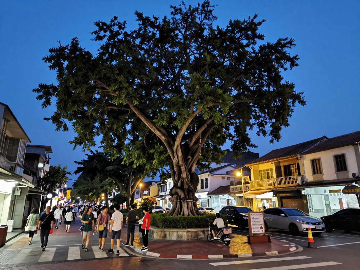 Kaohsiung Taiwan Indigo Twilight Street Scene with Banyan Tree and Busy Pedestrians in in Kaohsiung, Taiwan