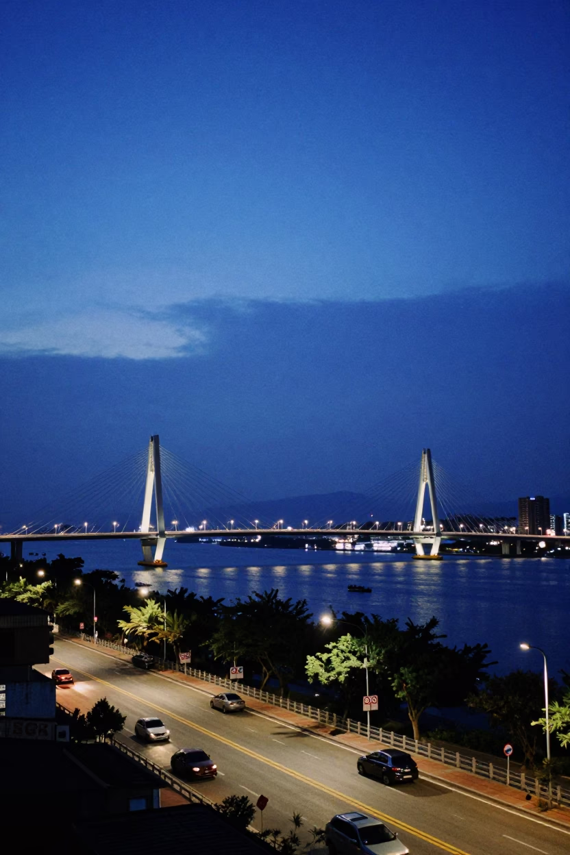 Kaohsiung Taiwan indigo twilight street scene with river view and local vendors in in Kaohsiung, Taiwan