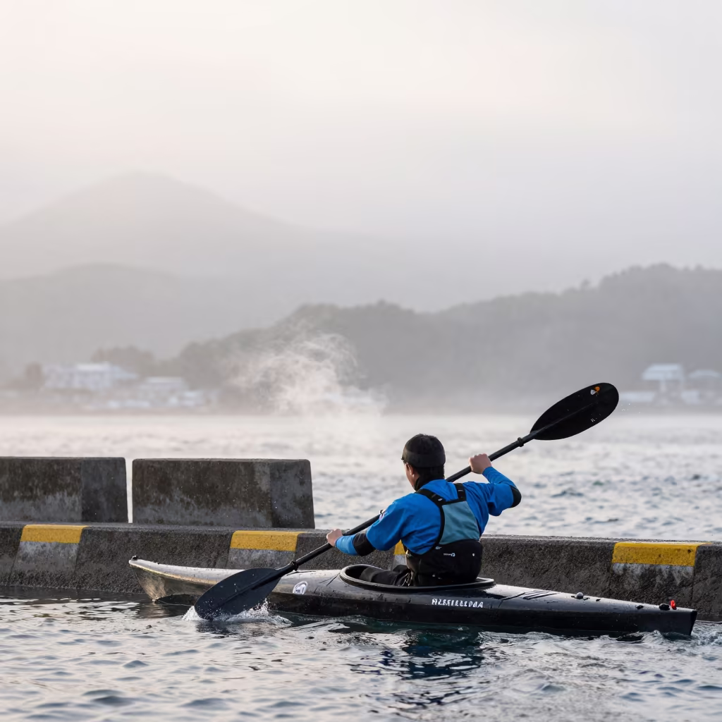 Kayaker in Fog Near Hiroshima Road Barrier in along a beach near Hiroshima