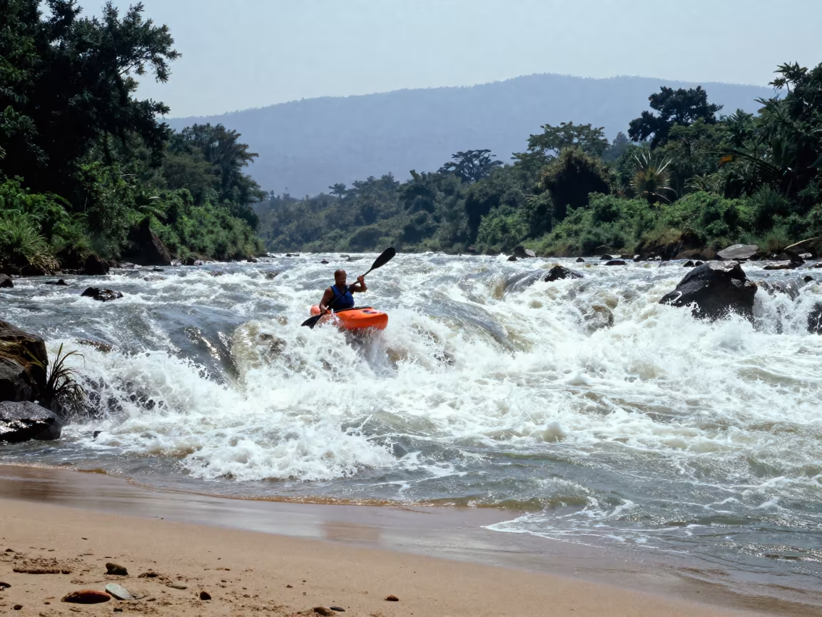Kayaker Navigating Whitewater Rapids Near Gulu in along a beach near Gulu