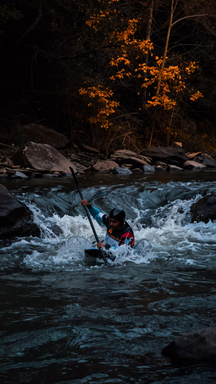 Kayaker in Standing Wave Under Starlight Gorge in by a riverbank near Tezpur