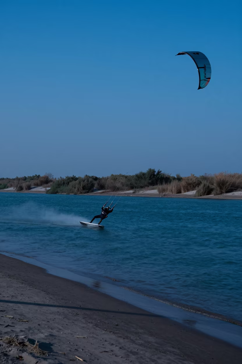 Kite Surfer Twilight Over Karachi River in by a riverbank near Karachi