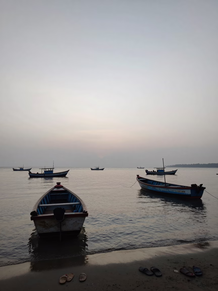Kochi India harbor dawn light with fishing boats and slippers on wooden pier in in Kochi, India