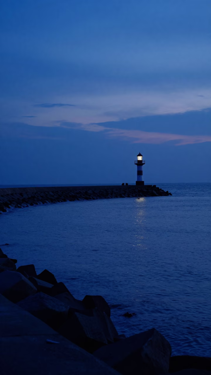 Kochi India indigo twilight harbor breakwater curve and lonely beacon light in in Kochi, India