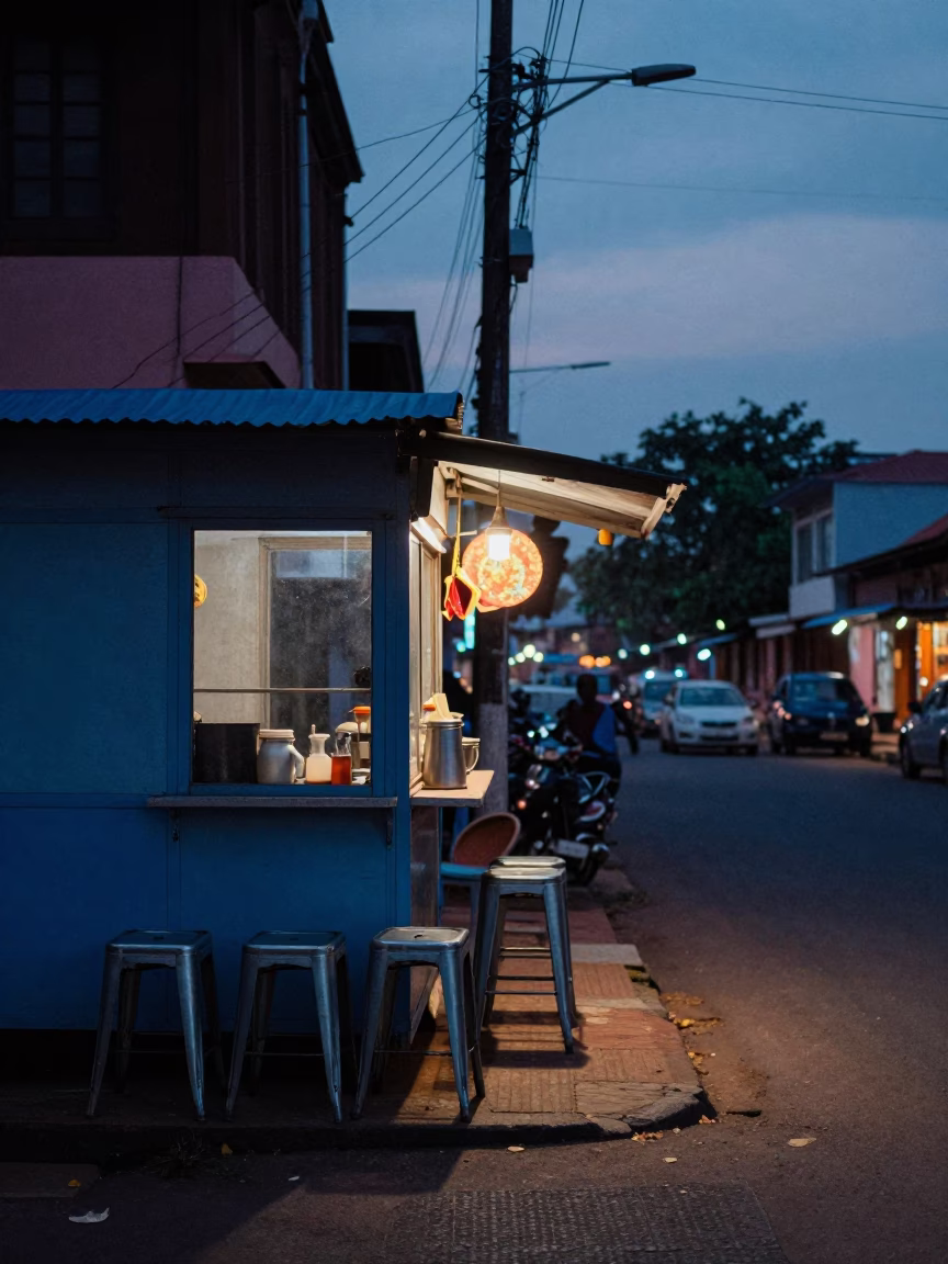 Kochi India Indigo Twilight Street Scene with Metal Stools and Local Commerce in in Kochi, India