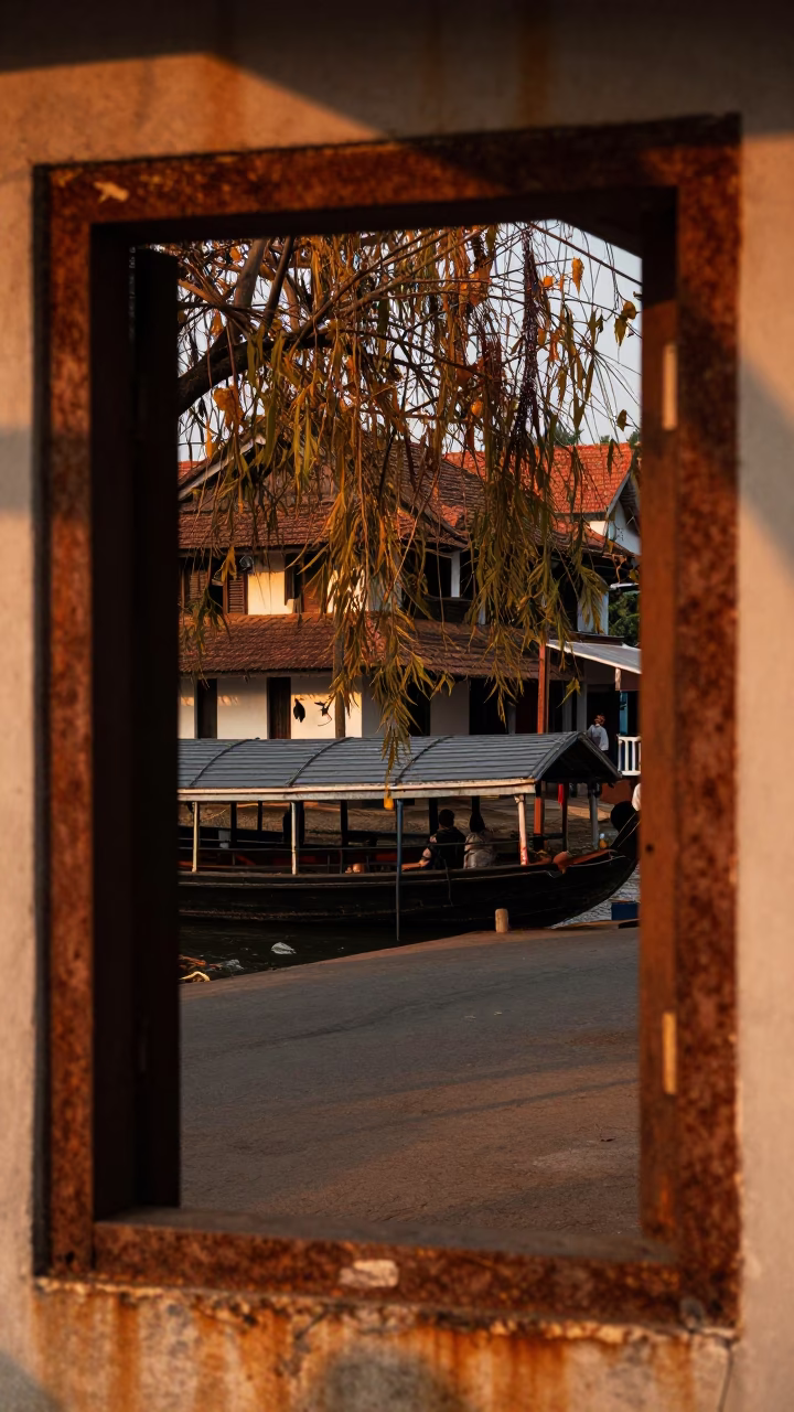 Kochi Kerala Street Scene Honeyed Evening Light Rust Frame Houseboat Heliconia in in Kochi, India