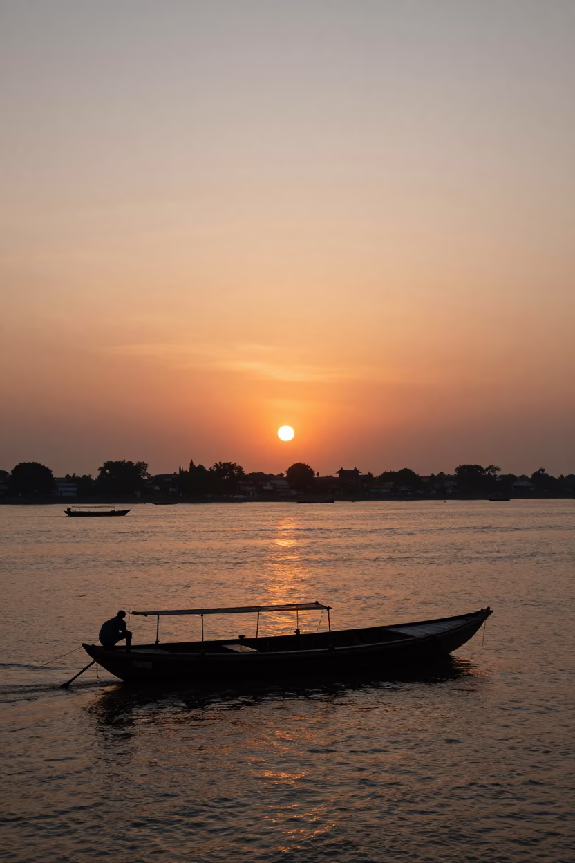 Kolkata Sunset Skyline Over Hooghly River with Traditional Boats and Urban Architecture in in Kolkata, India