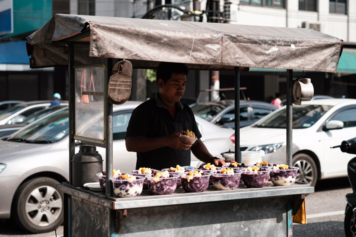 Kuala Lumpur street vendor selling açaí bowls under harsh noon glare in in Kuala Lumpur, Malaysia