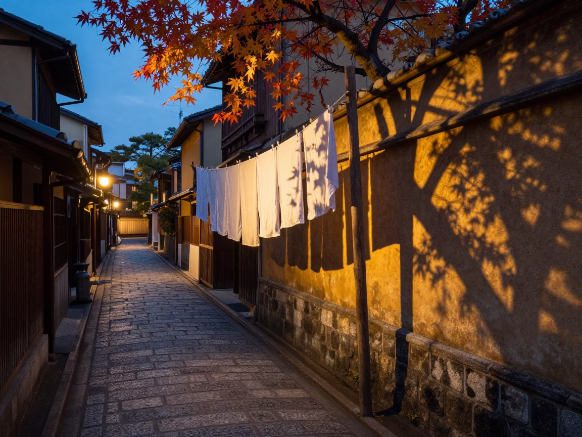 Kyoto Alleyway Dusk with Hanging Laundry and Dappled Leaf Shadows in in Kyoto, Japan