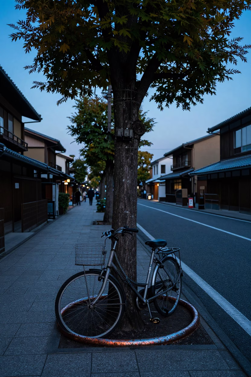 Kyoto blue hour street scene with tree and dented metal rim in in Kyoto, Japan
