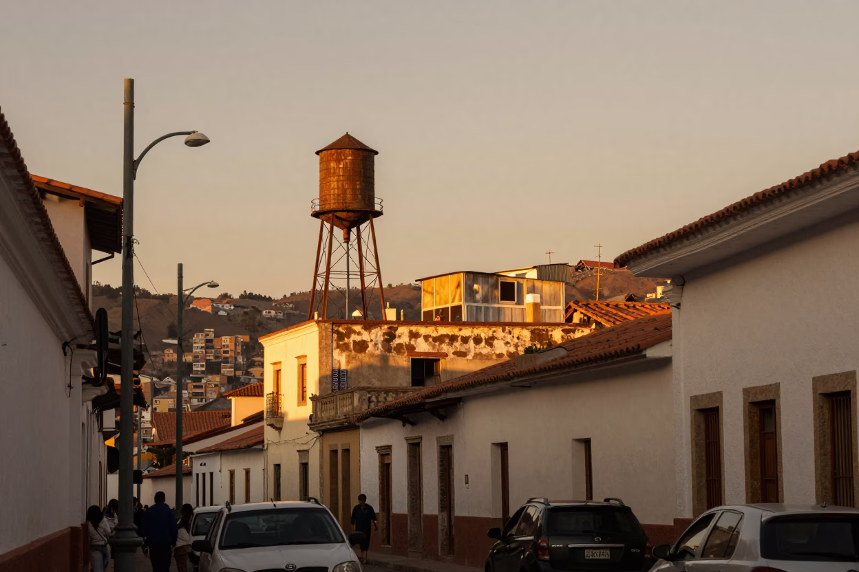 La Paz Bolivia Evening Street Scene With Rooftop Water Tower And Camellia Bush in in La Paz, Bolivia