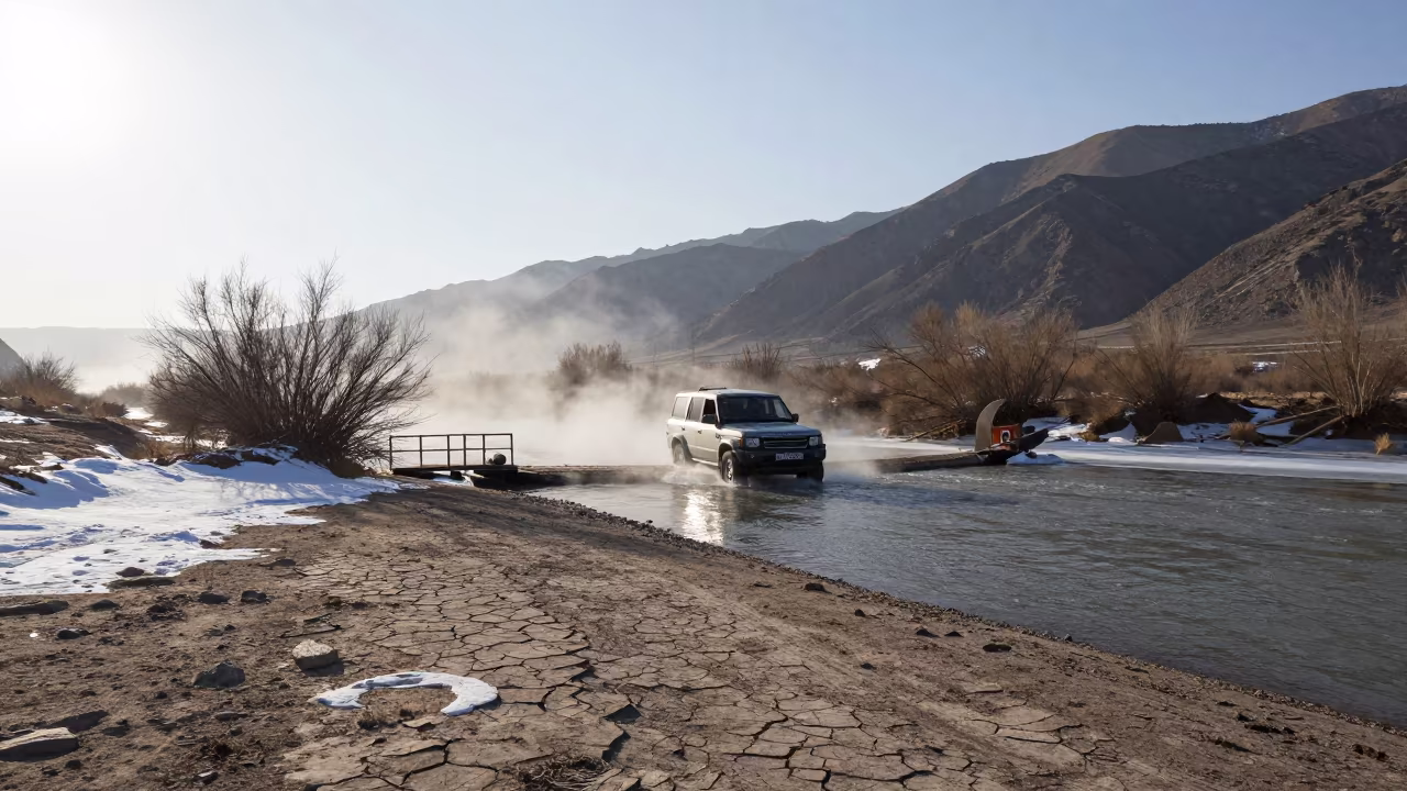 Land Rover Crossing Winter River Uzbekistan in across a remote ferry crossing in Uzbekistan