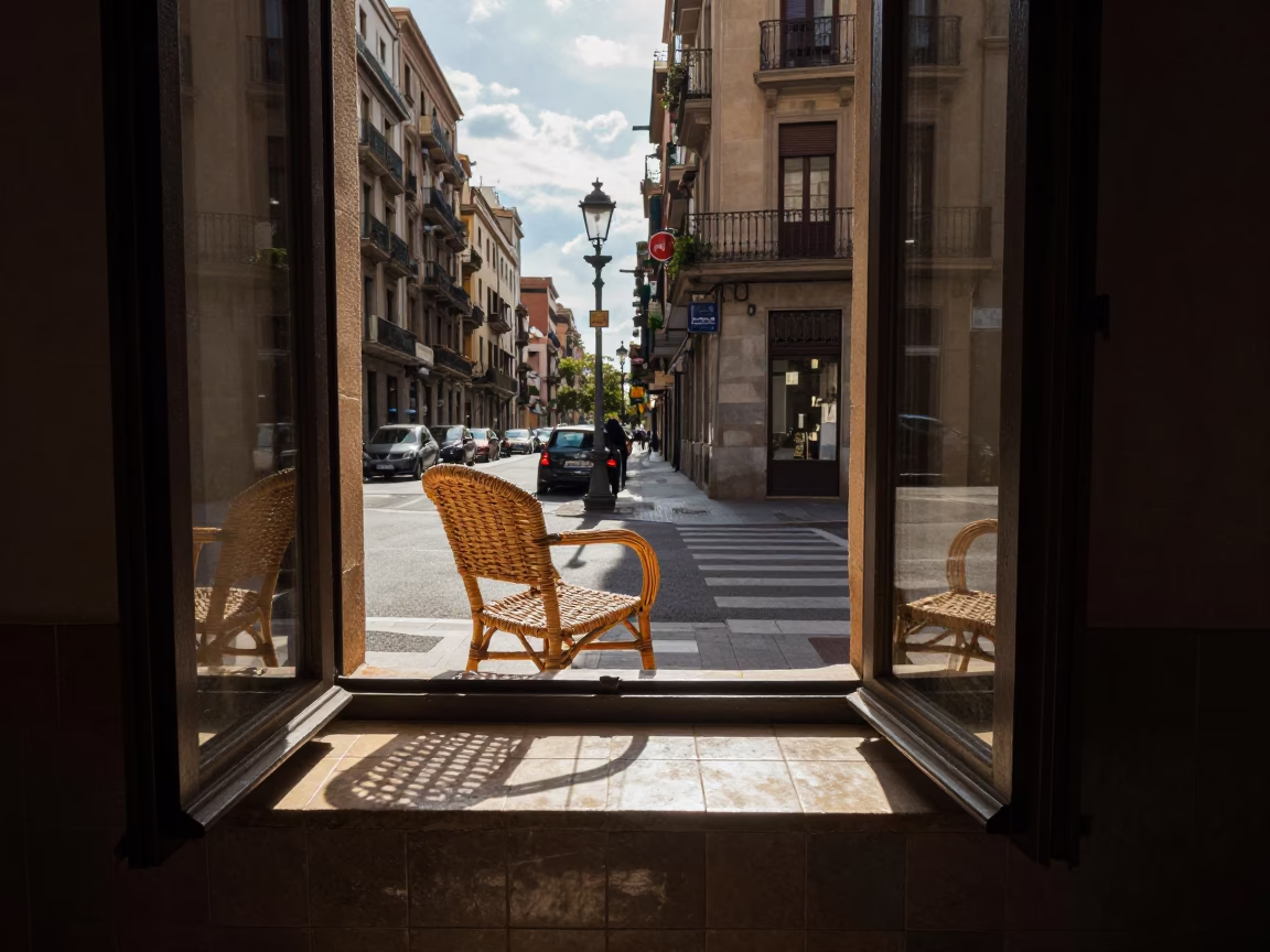 Late Afternoon Barcelona Street Scene with Wicker Shadow and Glass Bottle on Balcony in in Barcelona, Spain