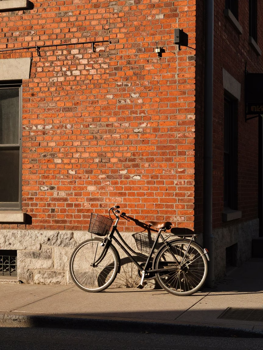 Late Afternoon Montreal Street Scene With Bicycle Leaning Against Brick Cafe Wall in in Montreal, Quebec, Canada