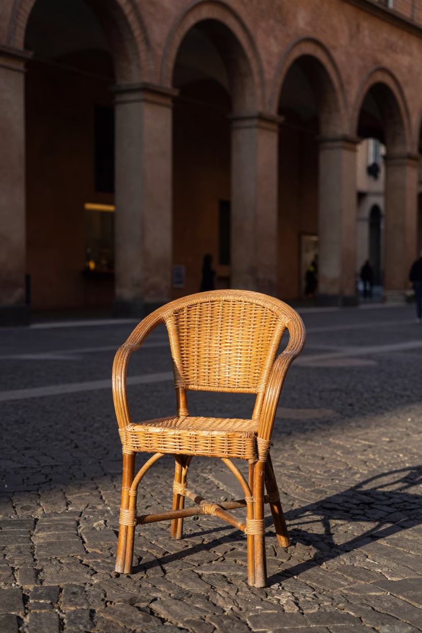 Late Afternoon Street Scene in Bologna Italy with Rattan Chair and Glass Carafe in in Bologna, Italy