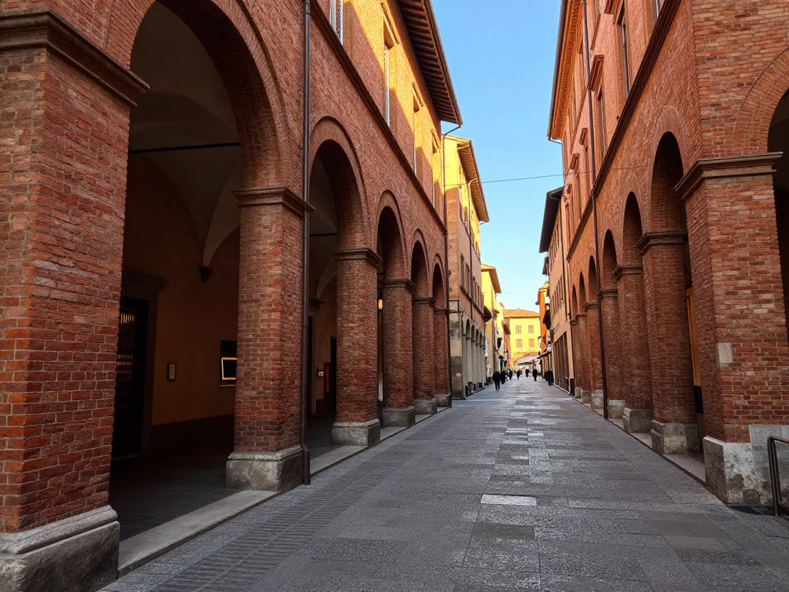 Late Afternoon Street Scene in Bologna Italy with Red Brick Porticoes and Clear Sky in in Bologna, Italy