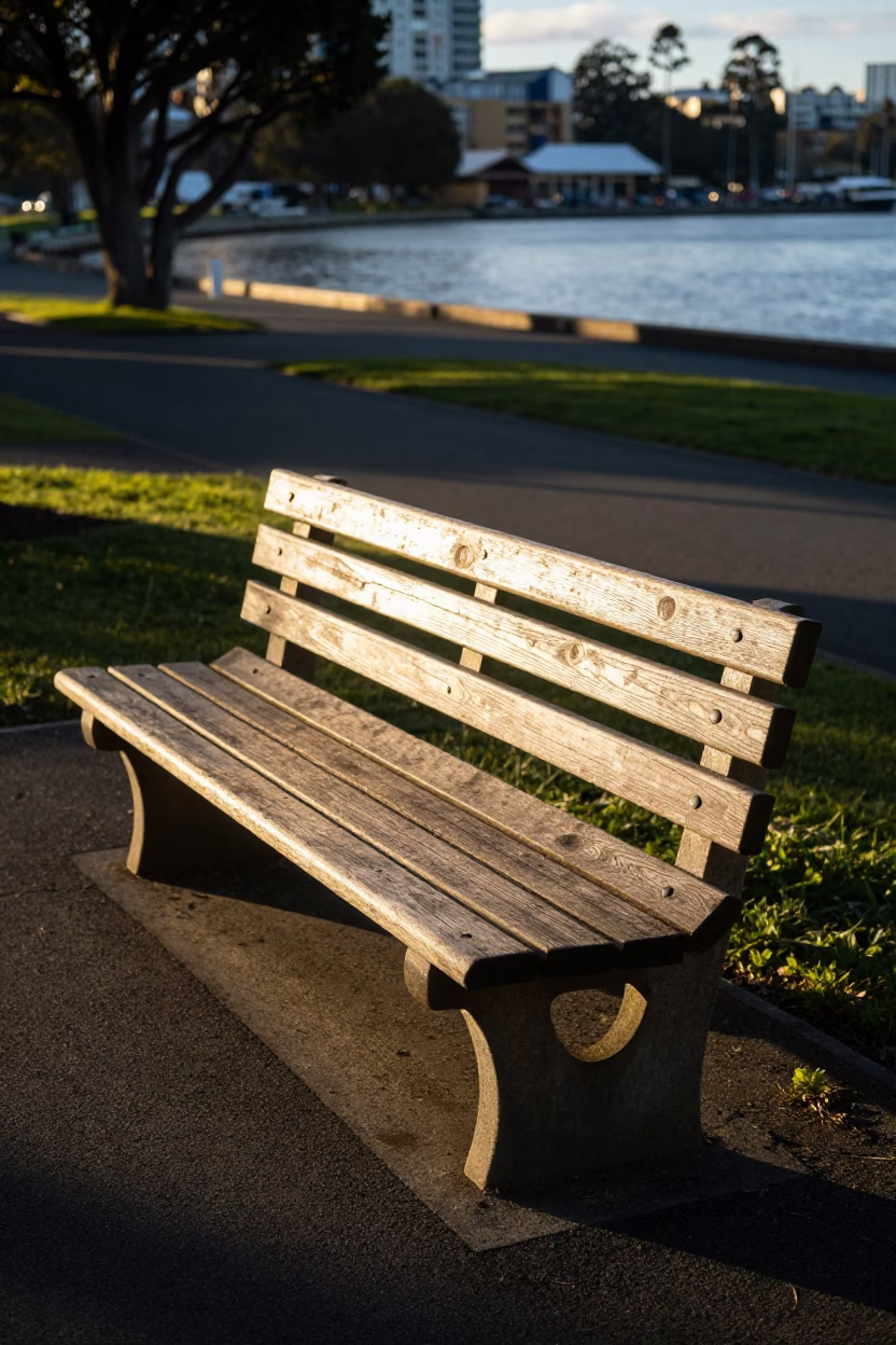 Late afternoon sunlight casting stripes across a wooden bench in Hobart Tasmania in in Hobart, Tasmania, Australia