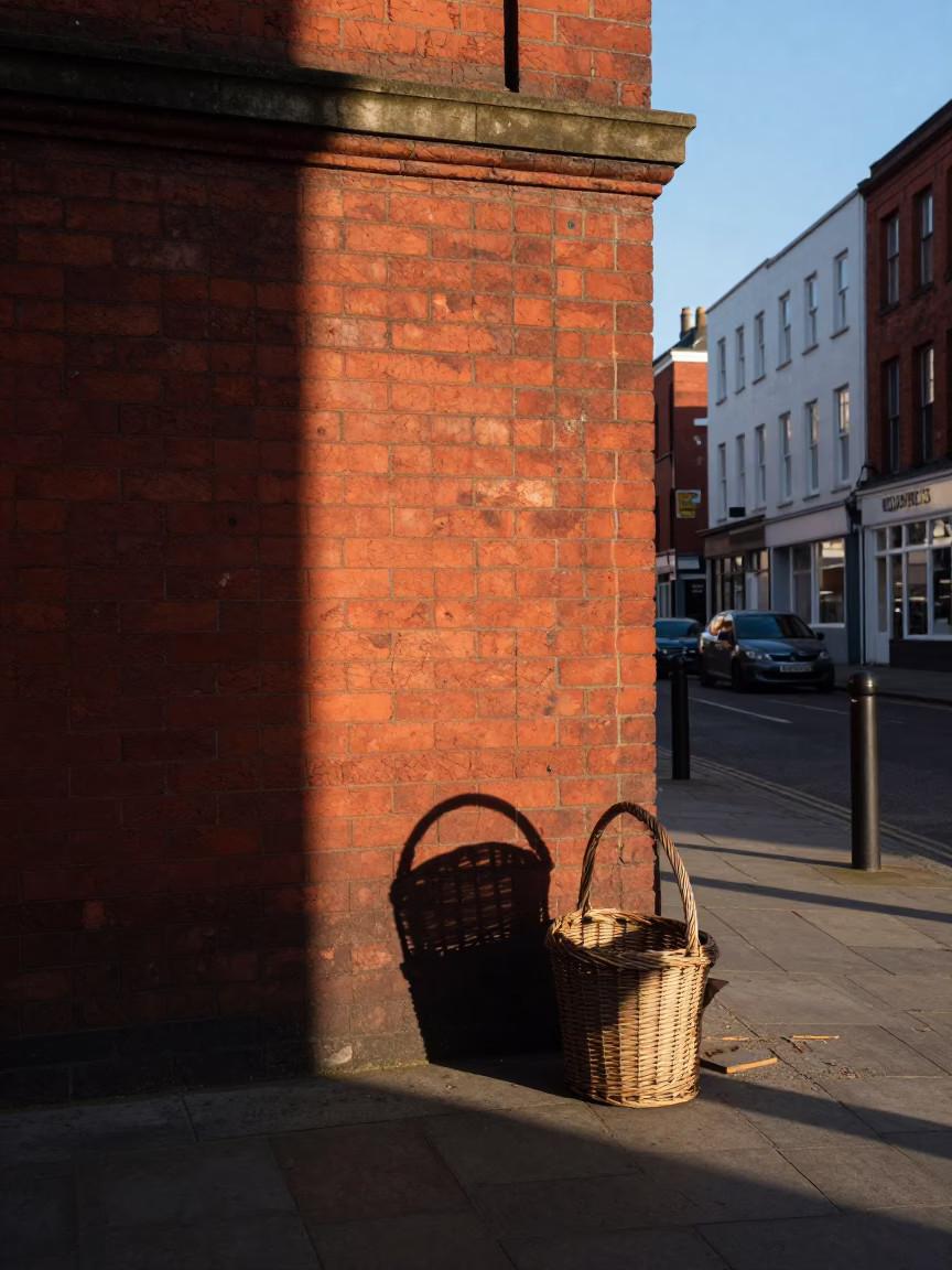 Late Morning Liverpool Street Scene with Wicker Basket Shadow on Red Brick Wall in in Liverpool, United Kingdom