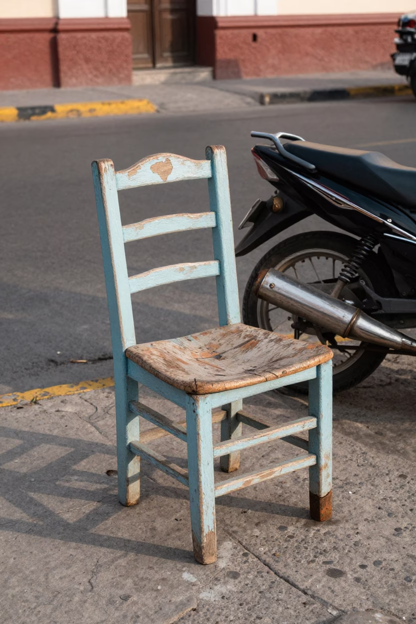Late Morning Street Scene in Lima Peru with Ladder-Back Chair and Motorcycle in in Lima, Peru