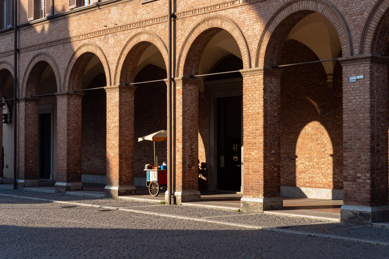 Late Morning Sunlight on Bologna Porticoes with Vintage Enamel Pitcher and Local Street Scene in in Bologna, Italy