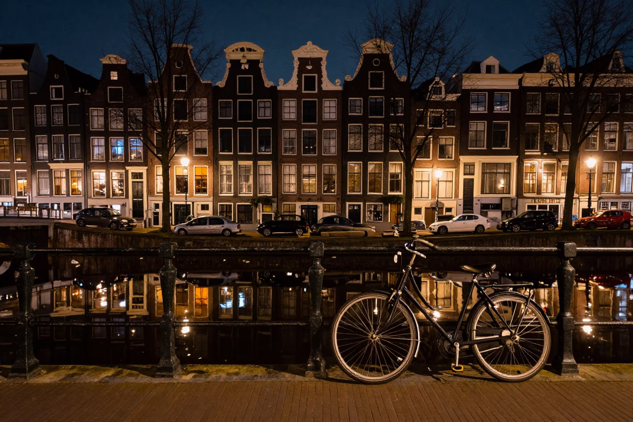 Late Night Amsterdam Canal Reflections with Bicycle and Cobblestone Street Scene in in Amsterdam, Netherlands