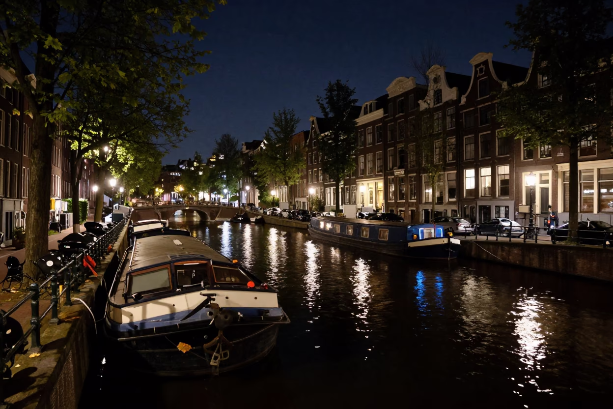 Late Night Amsterdam Canal Scene with Barge and Leaf Shadows in in Amsterdam, Netherlands