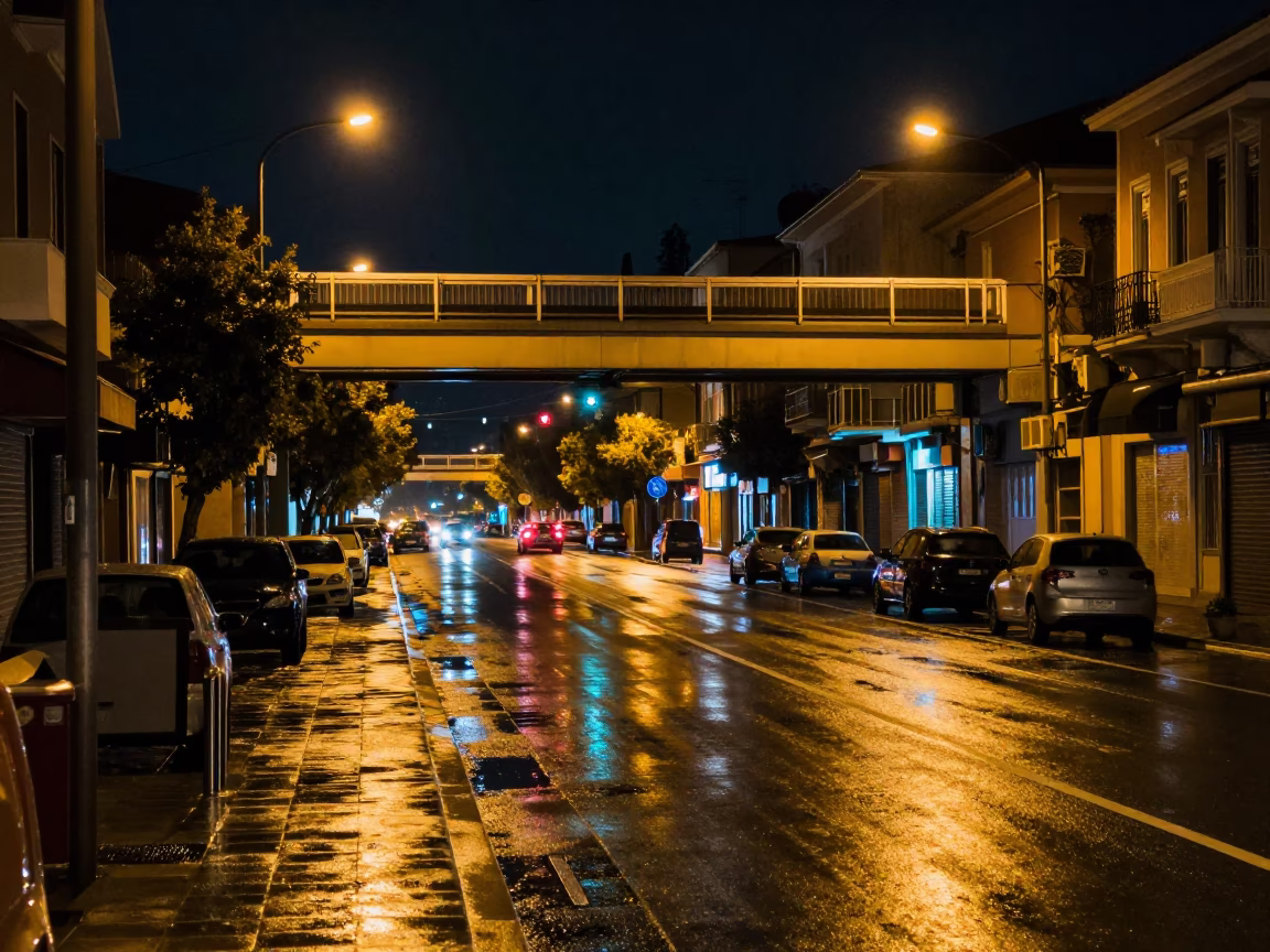 Late Night Athens Street Scene with Glowing Overpass and Rain-Slicked Pavement in in Athens, Greece