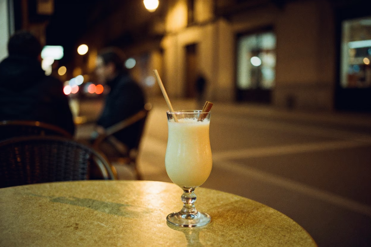 Late Night Barcelona Street Scene with Glass of Horchata and Steel Stool in in Barcelona, Spain