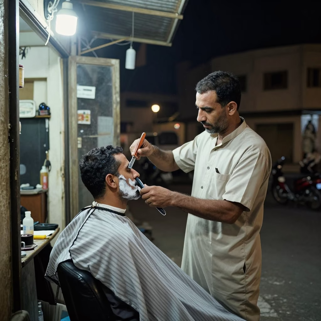 Late Night Cairo Street Barber with Straight Razor Under Neon Light in in Cairo, Egypt