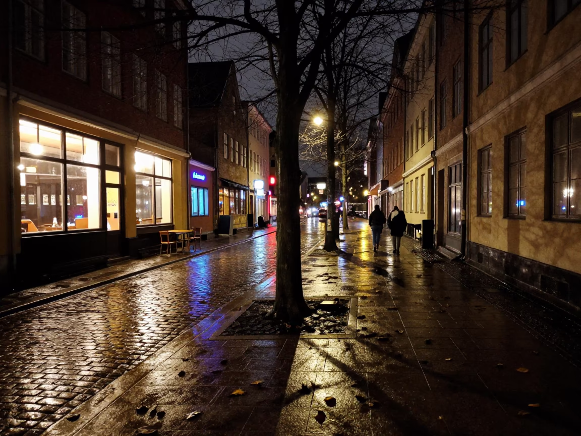 Late Night Copenhagen Street Scene with Leaf Shadows on Tiled Pavement in in Copenhagen, Denmark
