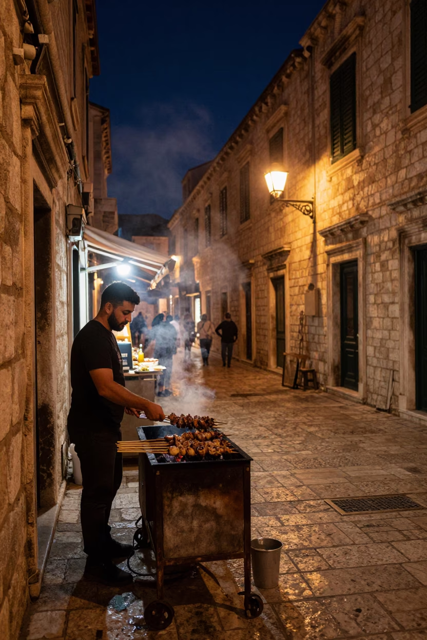 Late Night Dubrovnik Street Scene with Grilled Kebab and Historic Stone Walls in in Dubrovnik, Croatia