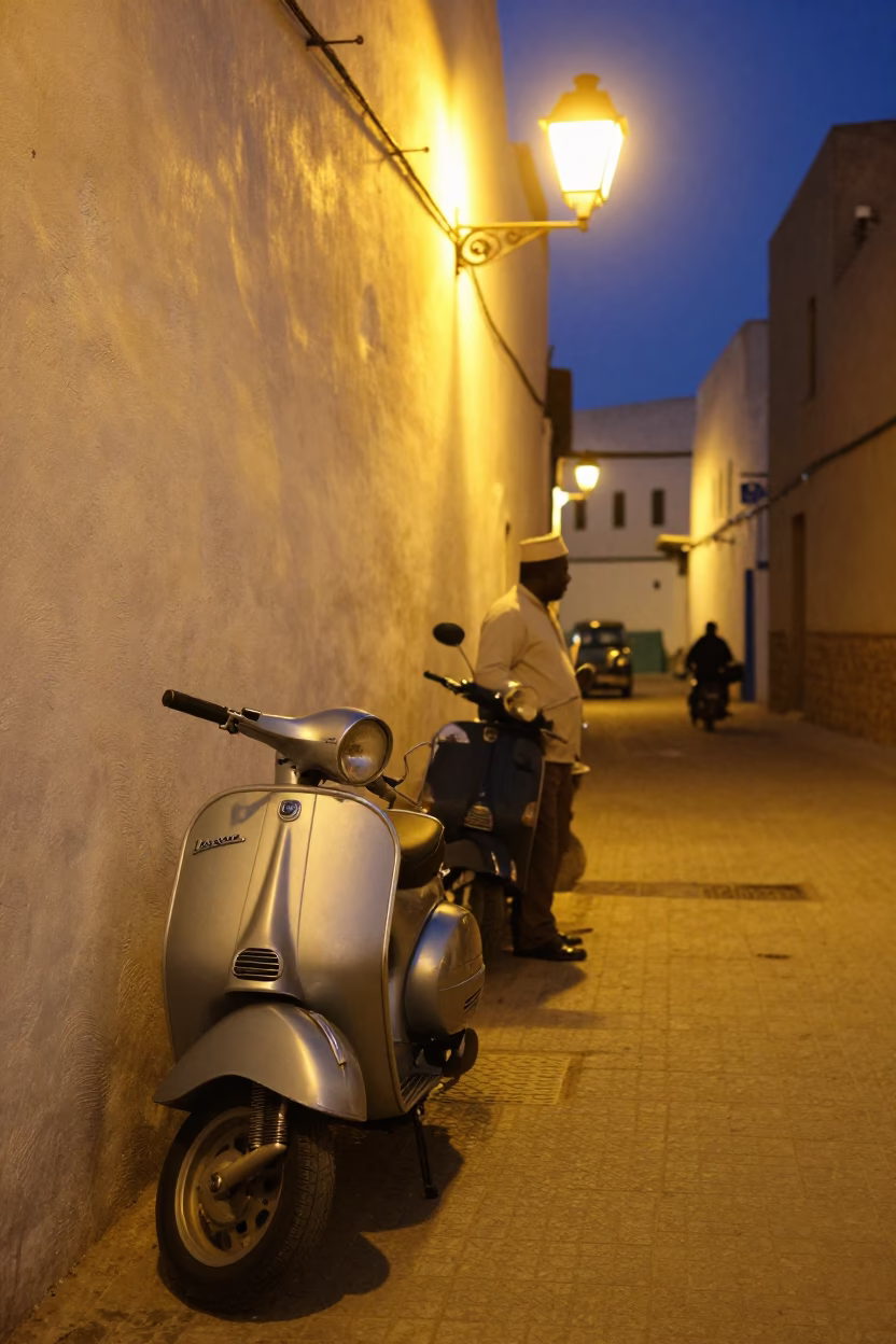Late Night Essaouira Street Scene with Vintage Vespa and Blue Porcelain in Morocco in in Essaouira, Morocco