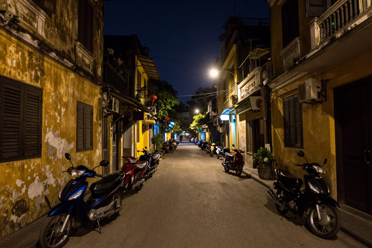 Late Night Hanoi Street Scene with Motorbikes and Colonial Architecture in in Hanoi, Vietnam