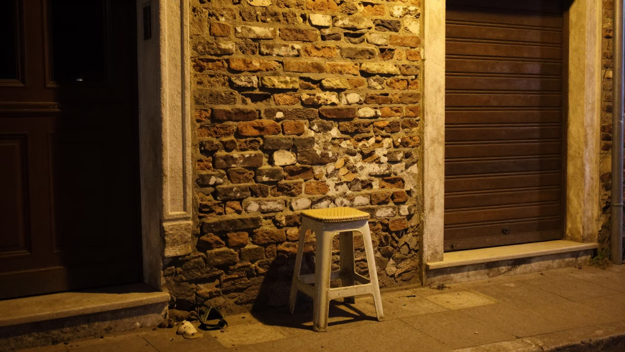 Late Night Izmir Street Scene with Work Stool and Rainy Window Reflections in in Izmir, Turkey