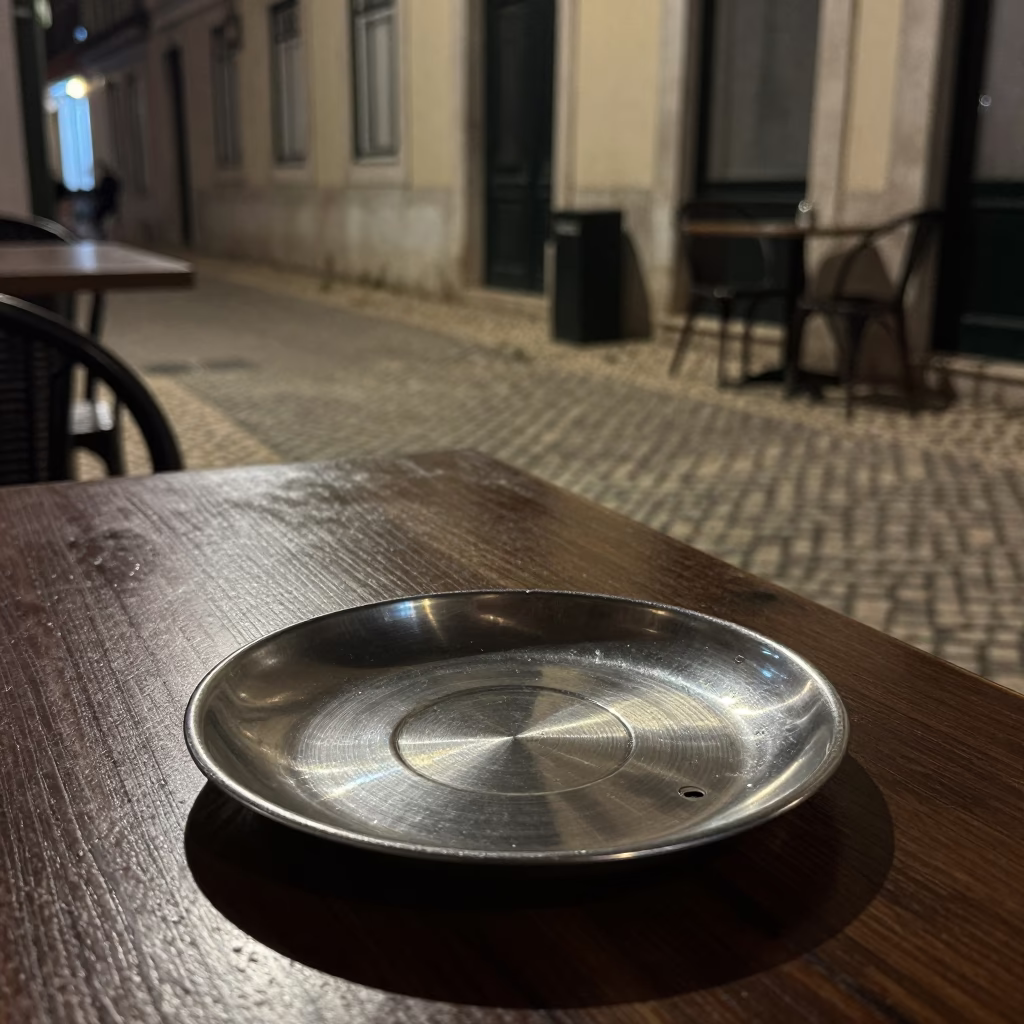 Late Night Lisbon Street Scene with Brushed Steel Saucer and Urban Ambiance in in Lisbon, Portugal