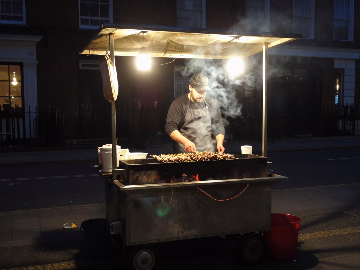 Late Night London Street Food Vendor Grilling Kebab Over Coals at Midnight in in London, United Kingdom